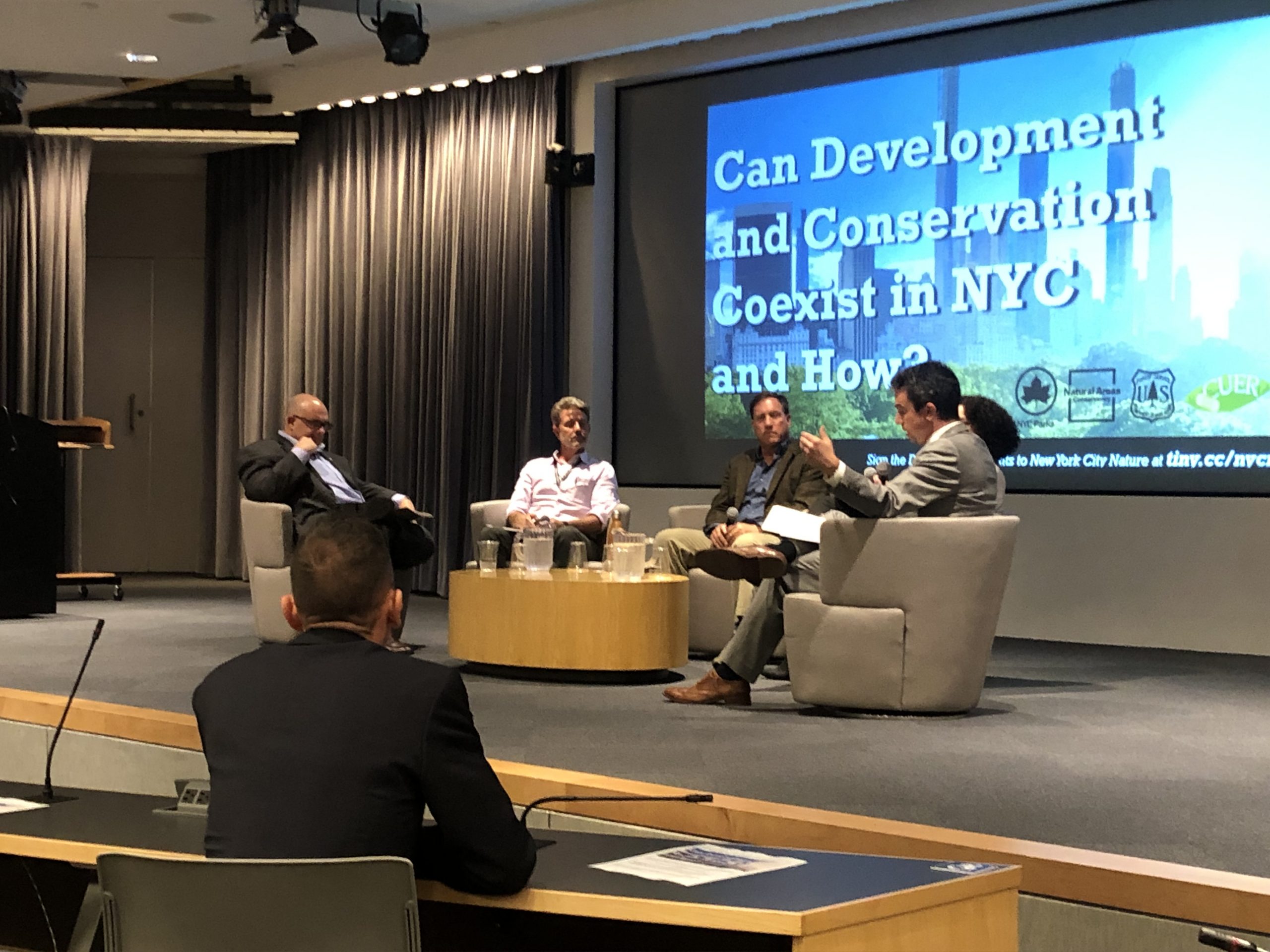 five panelists on stage at CUNY Law discuss environmental conservation and development in New York City