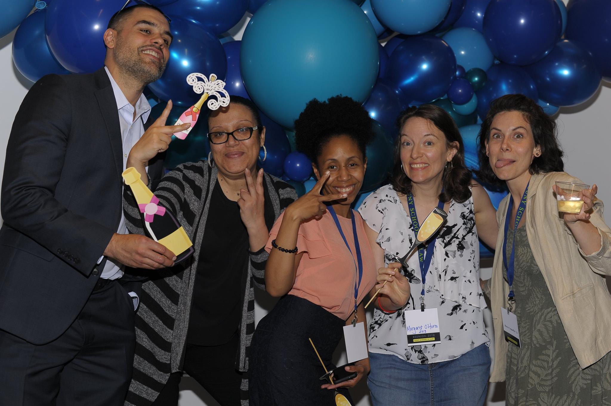 faculty and alumni pose in front of balloons at CUNY Law Reunion
