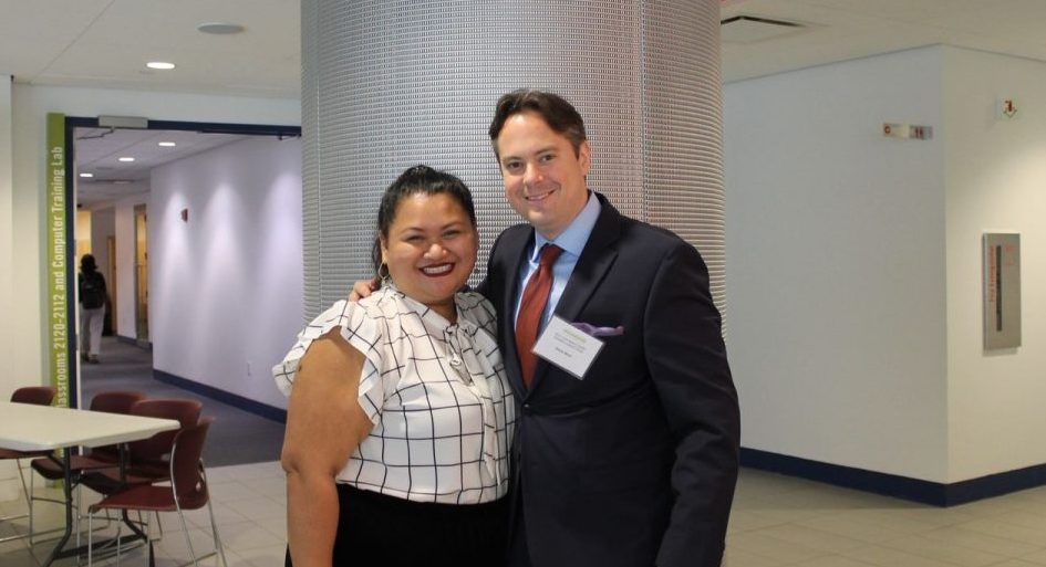 Jason Moor stands to the right of a CUNY Law student