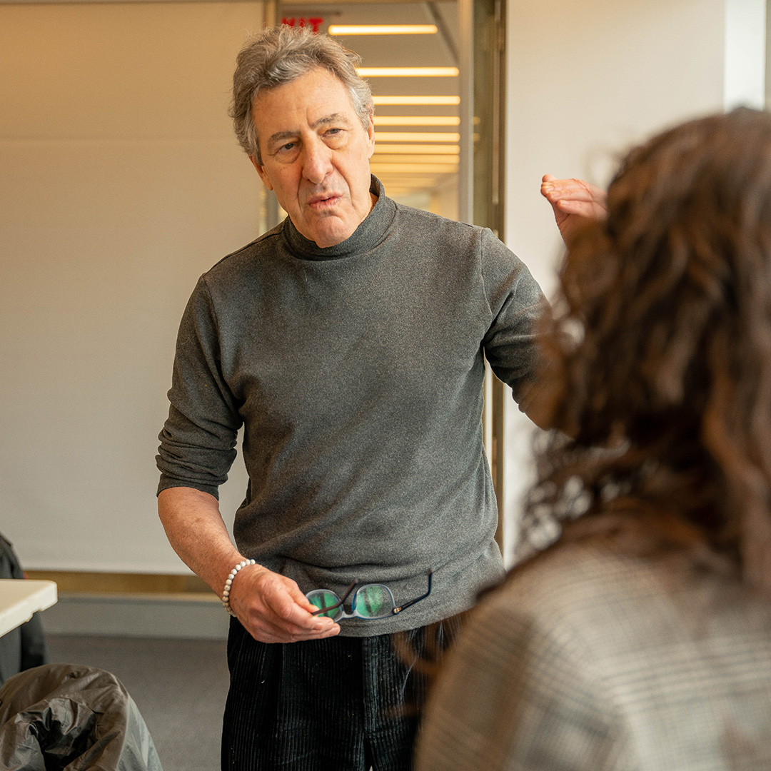 Professor standing speaking with a student