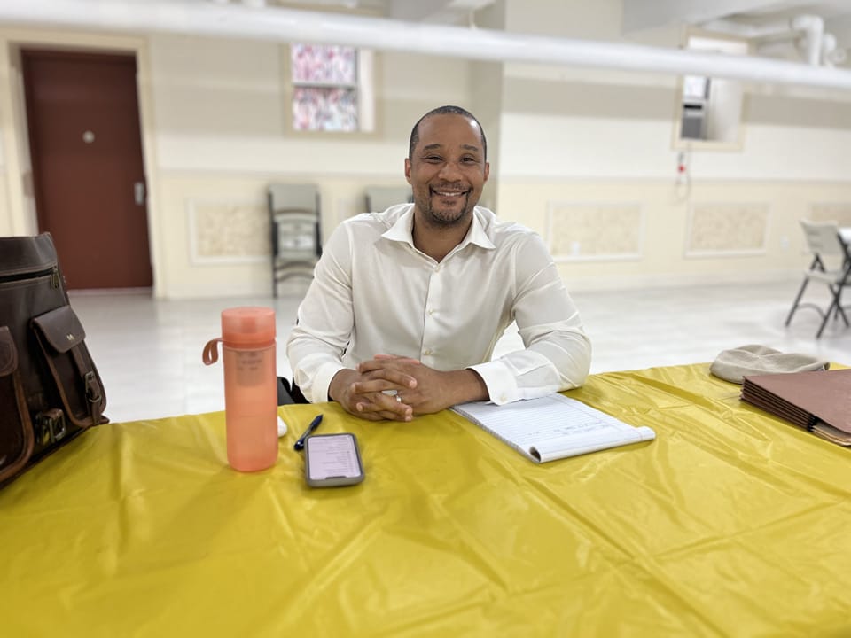 City Counseling Attorney Keith Allen ’09 sitting and smiling at the camera