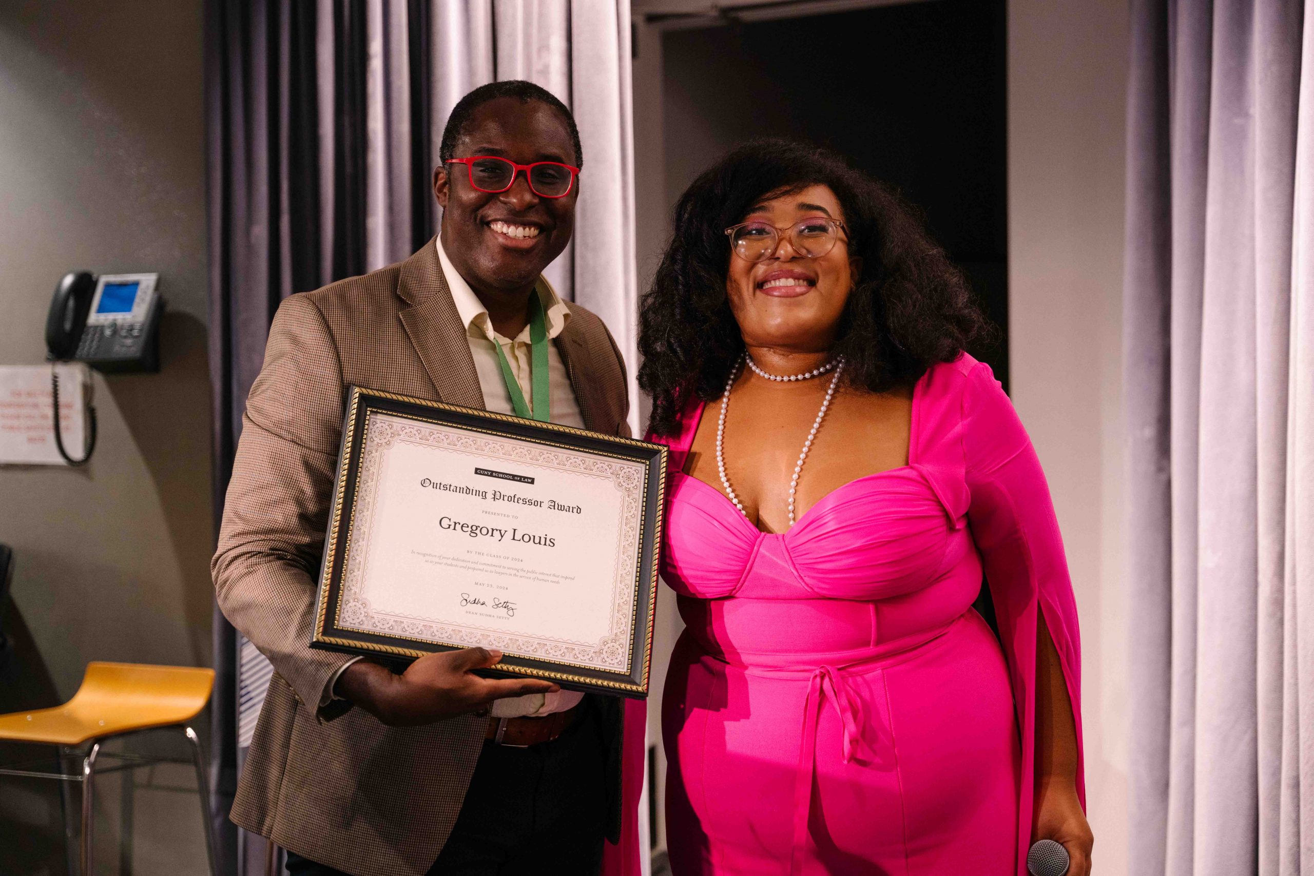 Gregory Louis receives an award at Student Grad Night 2024. .