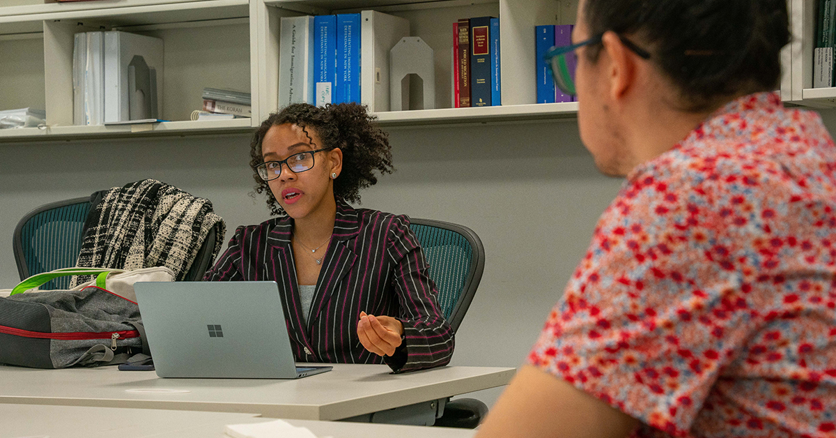 Student Jazmin Ortiz counseling Wendell in INRC classroom