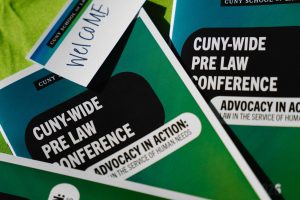 2026-01-16_Pre_Law_Conference_2nd_Annual (3 of 33) Close-up of printed materials for the CUNY-Wide Pre-Law Conference with the theme “Advocacy in Action: Law in the Service of Human Needs.”