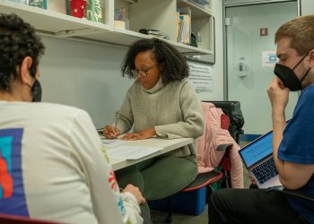 Students sitting around table in Clinic Classroom working together.