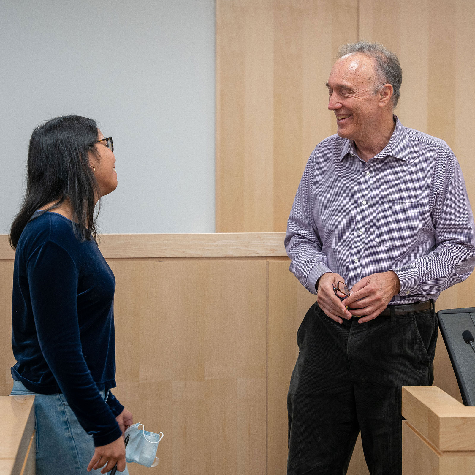 Professor speaking with student after class.