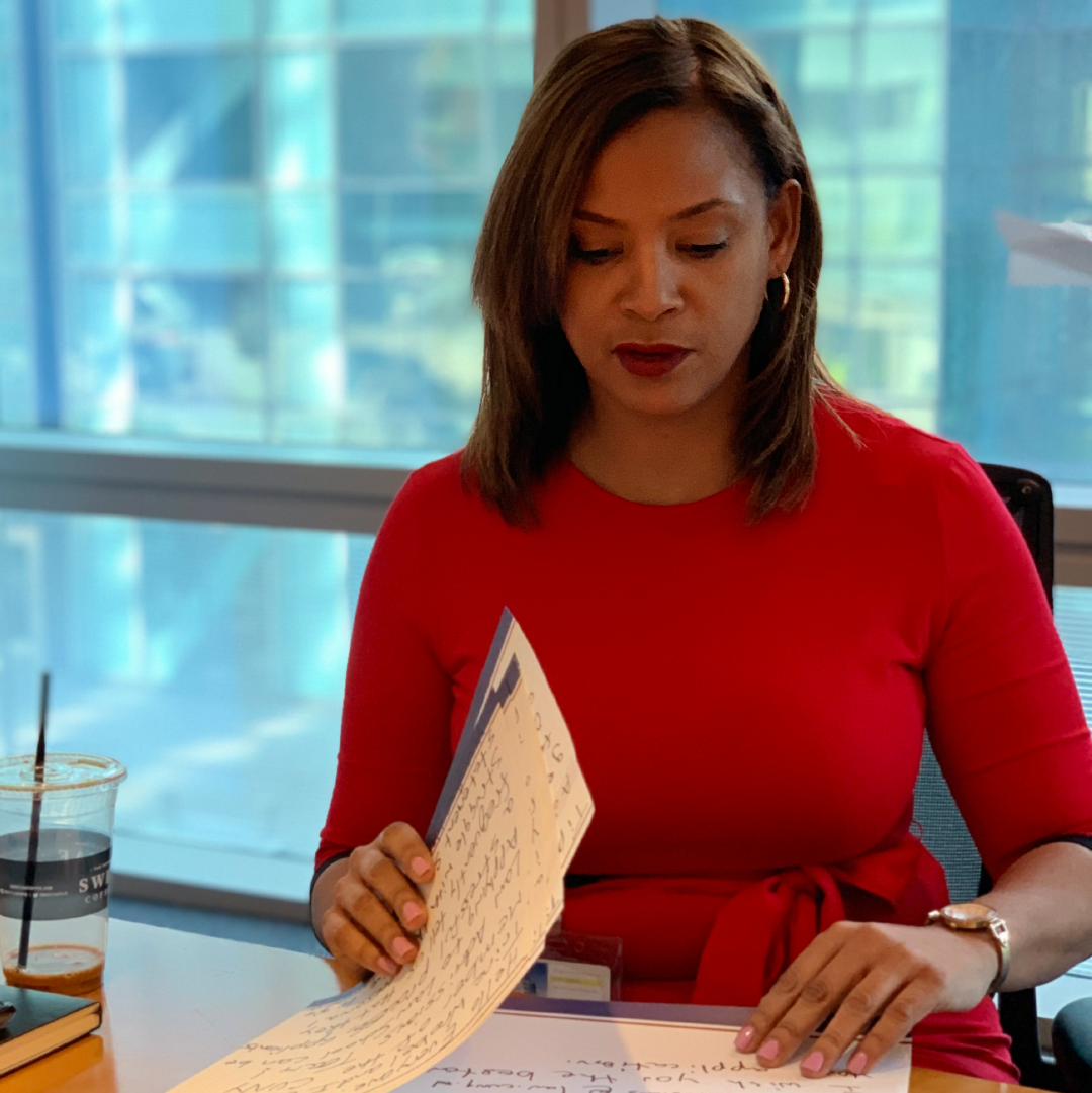 CUNY Law support staff sitting at table reviewing papers