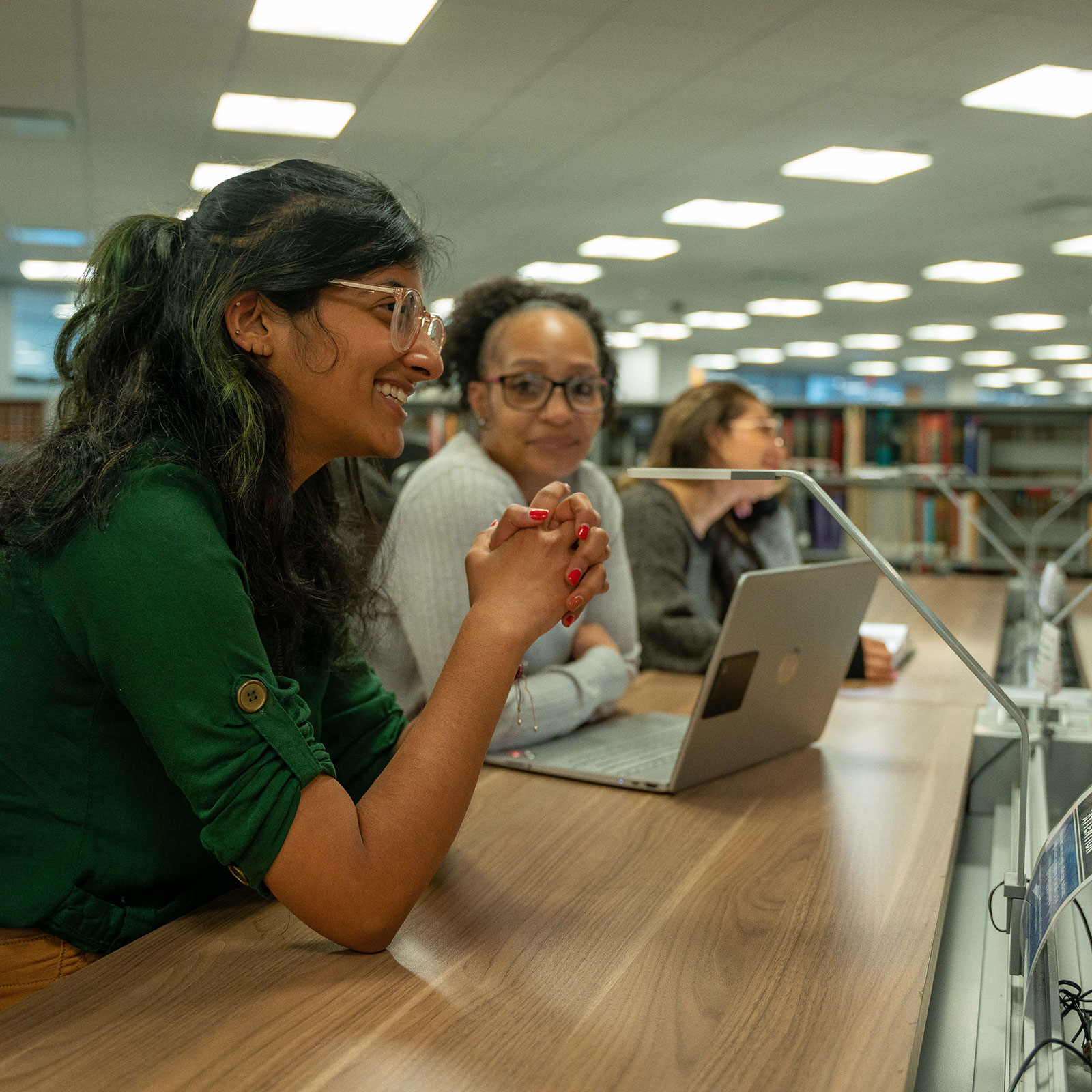 Students studying and collaborating in the library.