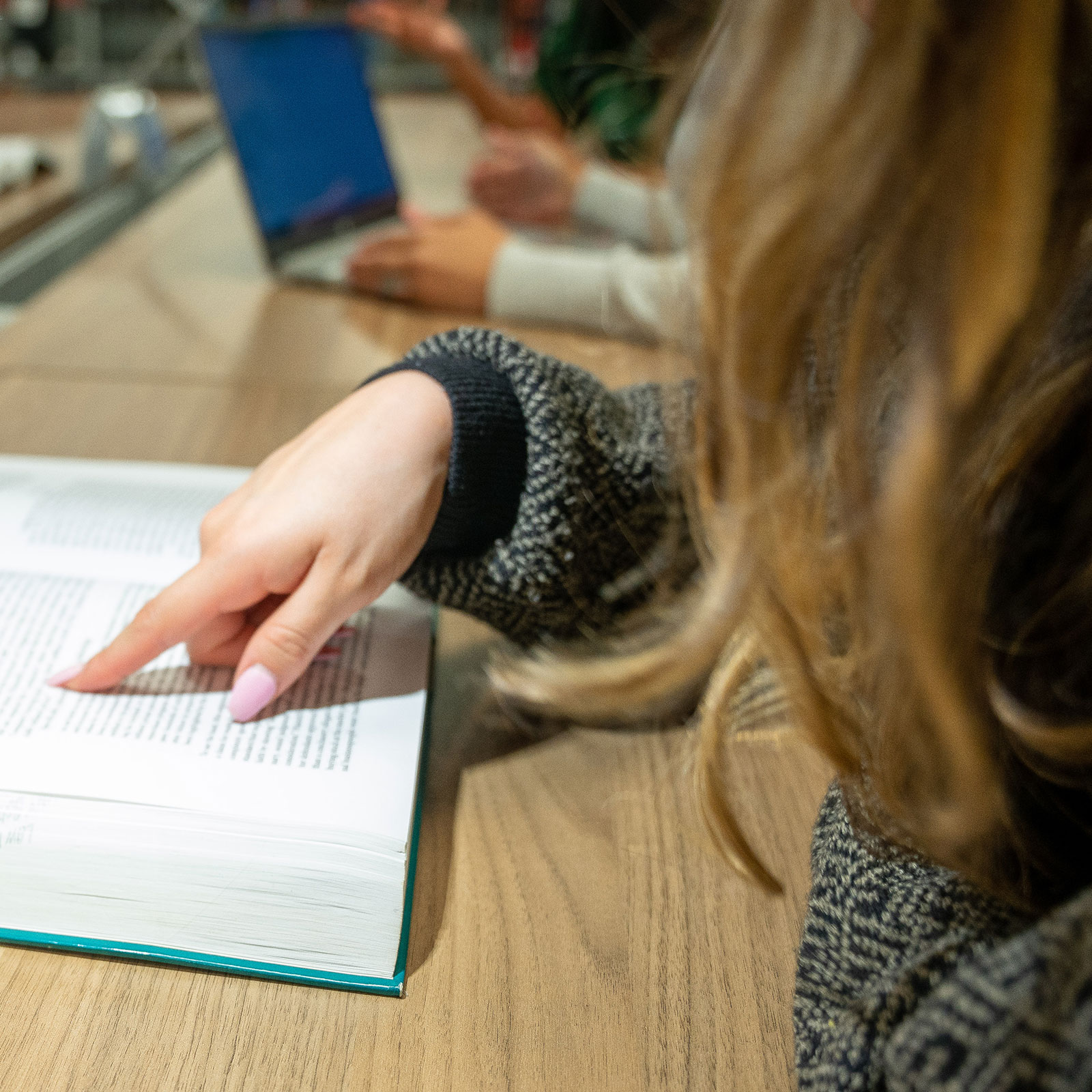 Female student reading book in the library