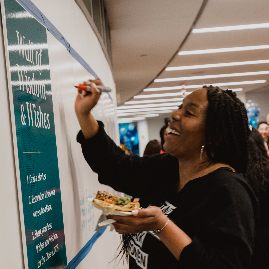 An alumnae shares wisdom and wishes on a poster