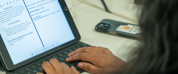 A person types on a tablet