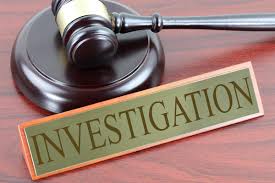 Investigation name plate in front of gavel