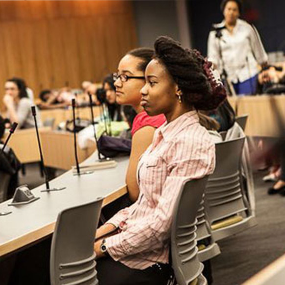 Students sitting a table in lecture hall