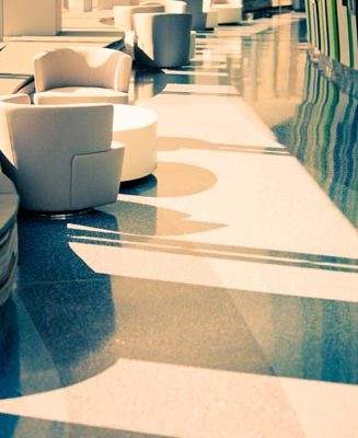 Comfy chairs with tables along the curved wall of windows on the first floor