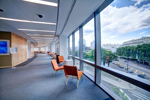 Seating and study area by a wall of windows with a view