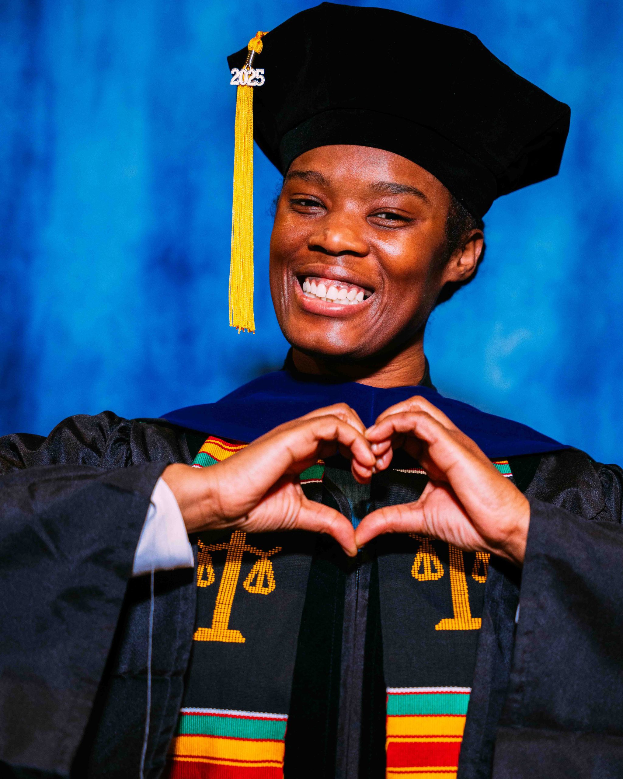 April Hurley poses for a Graduate portrait in graduation regalia.