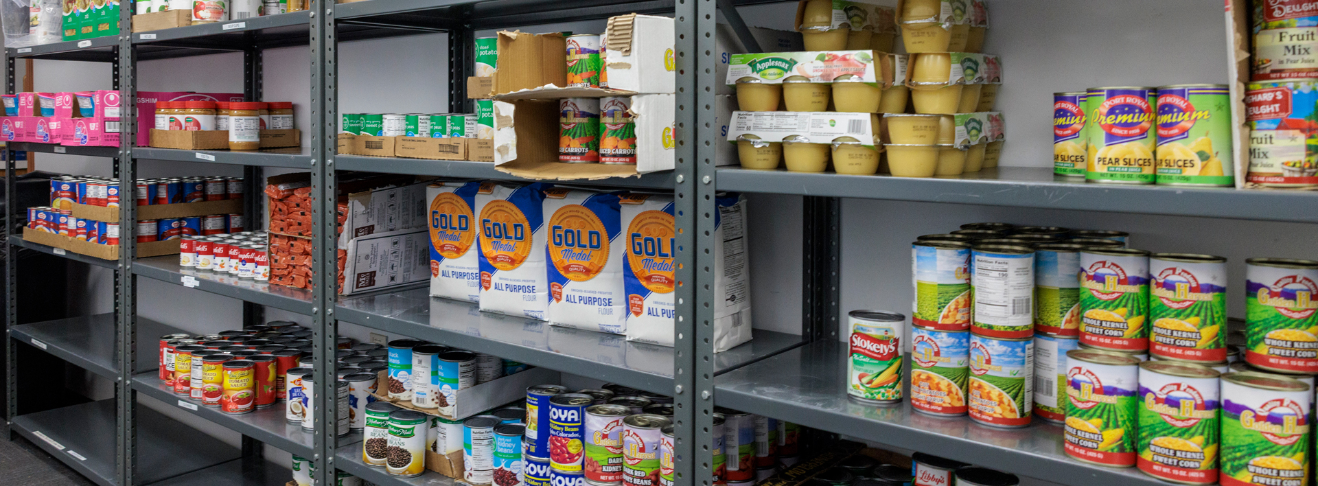 The shelves of the student pantry after a delivery from Foodcellar Market. stocked with canned goods, flour, and other non perishable items.