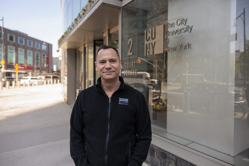 Metin Mangut, a partner at Foodcellar Market, standing in front of CUNY Law.